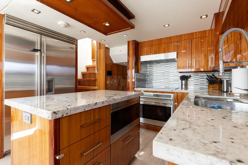 Slide: The Image of Luxurious kitchen in 2014 Hatteras 80 Motor Yacht Sky Lounge with modern appliances and sleek design. - 24