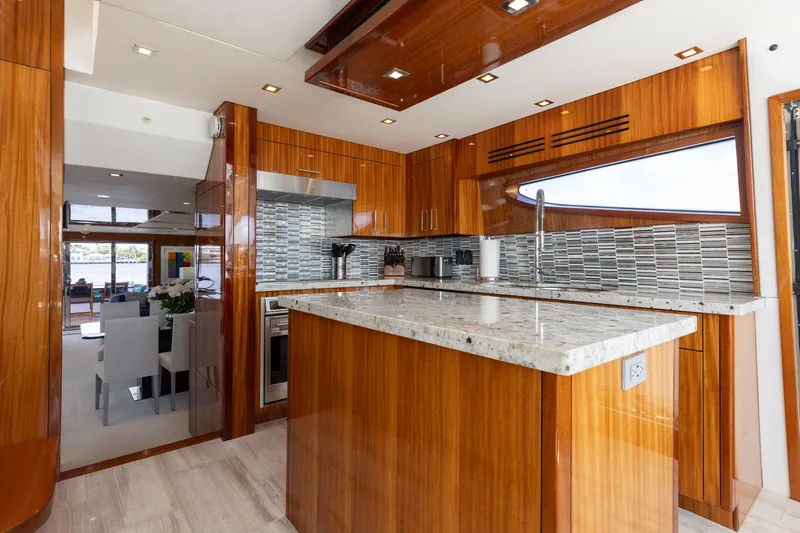 Slide: The Image of Luxurious kitchen interior of 2014 Hatteras 80 Motor Yacht Sky Lounge with wood cabinetry. - 26