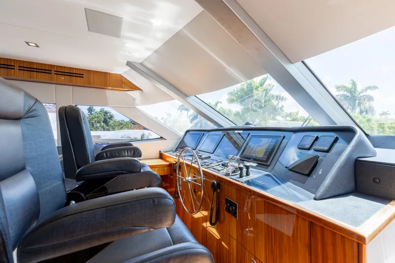 Slide: The Image of Luxurious helm of 2014 Hatteras 80 Motor Yacht Sky Lounge with modern controls and seating. - 30