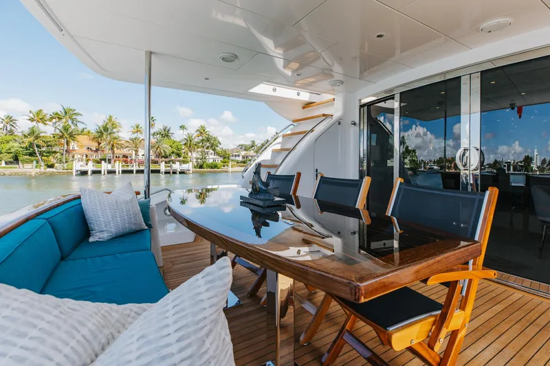 Slide: The Image of Luxurious 2014 Hatteras 80 Motor Yacht Sky Lounge with elegant outdoor seating and dining area. - 8