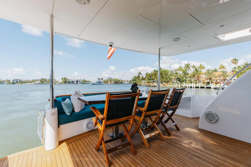Slide: The Image of Luxurious deck of 2014 Hatteras 80 Motor Yacht Sky Lounge with waterfront view. - 9