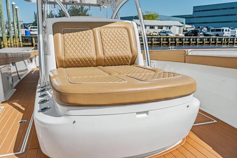 Slide: The Image of 2021 Valhalla Boatworks V-41 with tan quilted seating, docked at marina. - 10