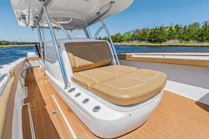 Slide: The Image of 2021 Valhalla Boatworks V-41 with tan seating, sleek design, and spacious deck on the water. - 12