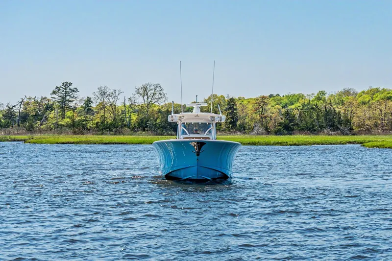 Slide: The Image of 2021 Valhalla Boatworks V-41 on water, surrounded by lush greenery. - 2
