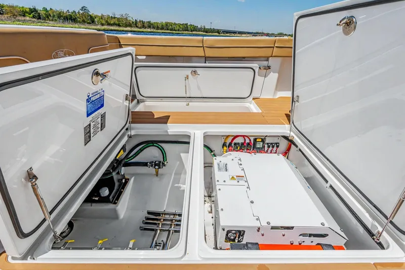 Slide: The Image of 2021 Valhalla Boatworks V-41 storage compartments open, revealing electrical and mechanical components. - 26