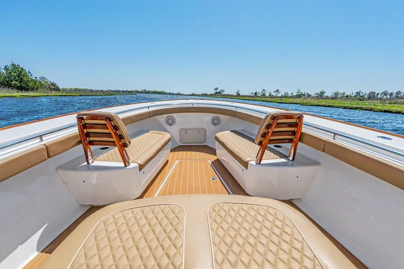 Slide: The Image of 2021 Valhalla Boatworks V-41 interior with tan seating and wooden accents on a sunny day. - 7