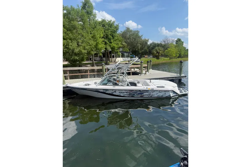 The Image of 2006 Correct Craft Super Air Nautique Team Edition boat docked on a sunny day. - 0