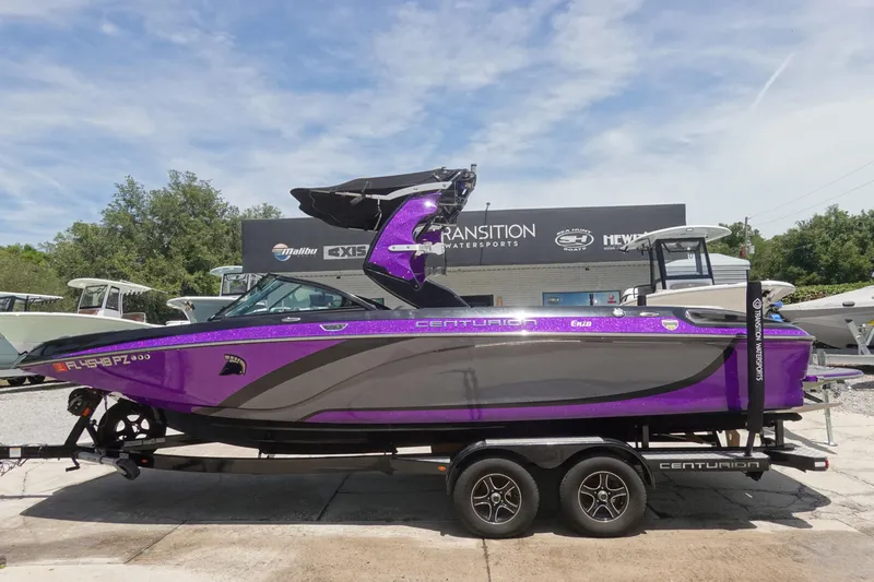 The Image of 2016 Centurion Enzo FS33 boat in vibrant purple on a trailer at a dealership. - 1