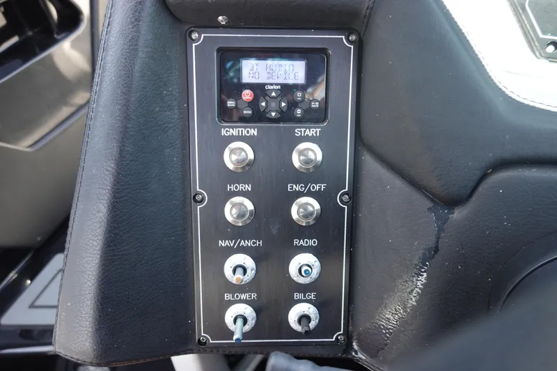 Slide: The Image of Control panel of a 2016 Centurion Enzo FS33 boat with various switches and buttons. - 13