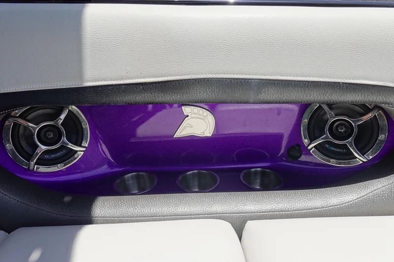 Slide: The Image of 2016 Centurion Enzo FS33 interior with purple panel, speakers, and cup holders. - 19