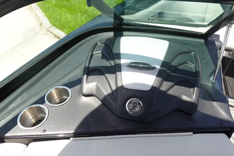 Slide: The Image of 2016 Centurion Enzo FS33 boat dashboard with cup holders and logo. - 22