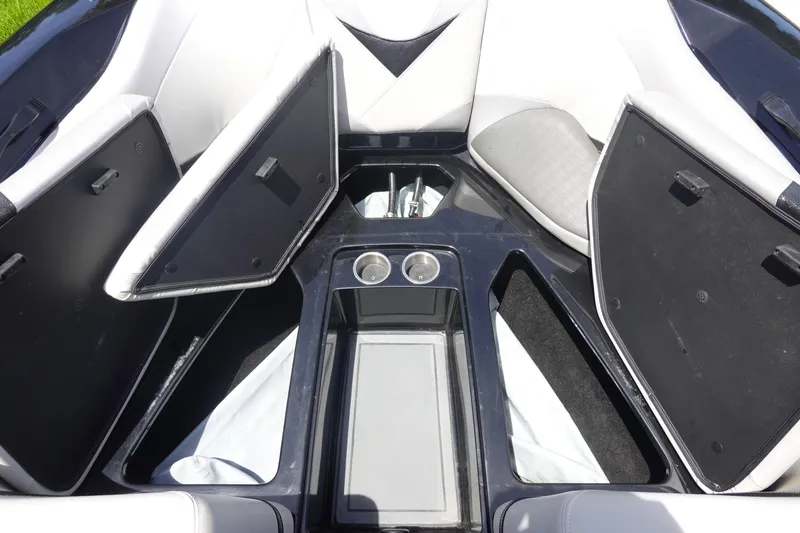 Slide: The Image of 2016 Centurion Enzo FS33 boat interior with open storage compartments and cup holders. - 27