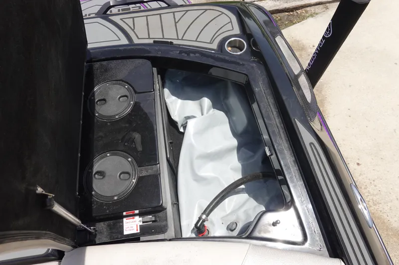 Slide: The Image of Open storage compartment of 2016 Centurion Enzo FS33 boat, showing internal components. - 33