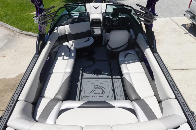 Slide: The Image of 2016 Centurion Enzo FS33 boat interior with spacious seating and modern dashboard design. - 7