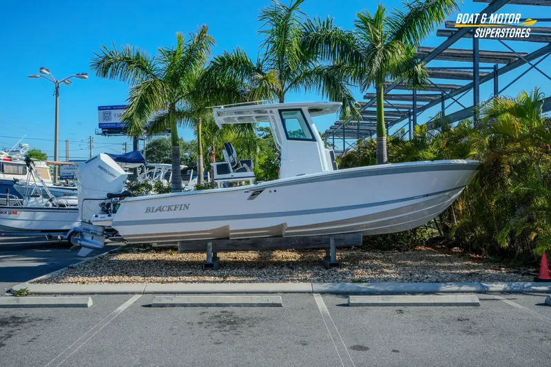 The Image of 2025 Blackfin 262 HB boat displayed outdoors with palm trees in the background. - 1