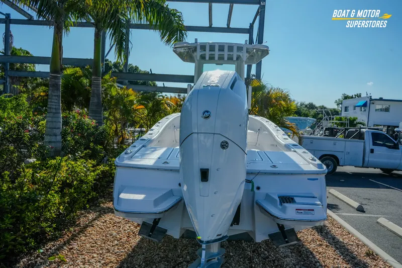 Slide: The Image of 2025 Blackfin 262 HB boat displayed outdoors at a dealership with palm trees. - 3
