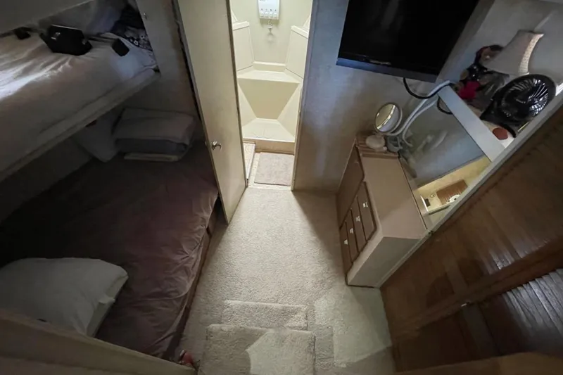Slide: The Image of Interior of 1973 Chris-Craft 45 Commander yacht with cozy sleeping quarters and storage. - 20