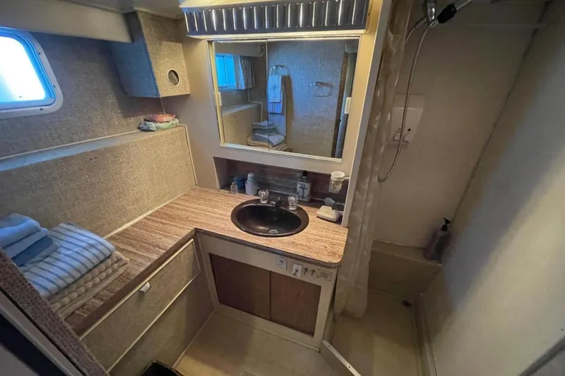 Slide: The Image of Bathroom interior of 1973 Chris-Craft 45 Commander yacht with sink, mirror, and shower. - 22