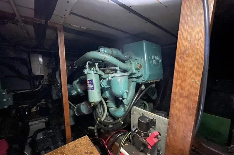 Slide: The Image of Engine room of a 1973 Chris-Craft 45 Commander, showcasing vintage machinery and components. - 23