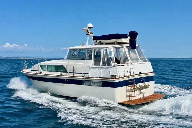Slide: The Image of 1973 Chris-Craft 45 Commander yacht cruising on open water. - 3