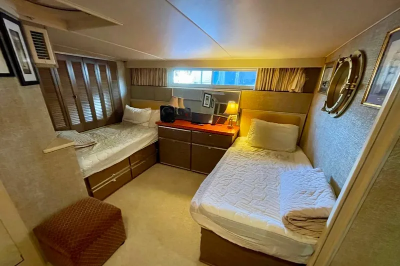 Slide: The Image of Interior of 1973 Chris-Craft 45 Commander yacht with twin beds and cozy decor. - 7