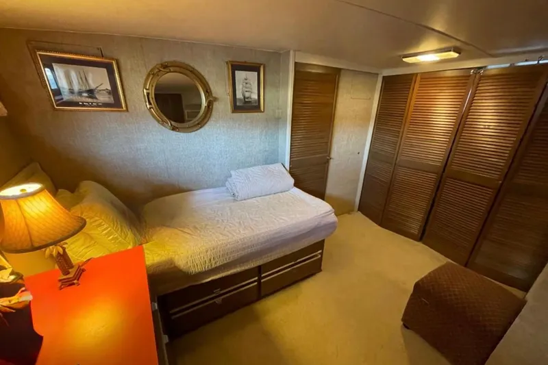 Slide: The Image of Cozy bedroom in 1973 Chris-Craft 45 Commander yacht with nautical decor and warm lighting. - 8