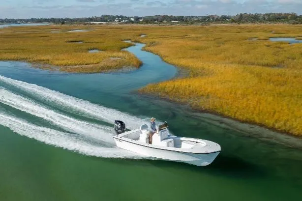 Slide: The Image of Privateer ROAMER II 2026 boat cruising through scenic marshland waterways. - 10