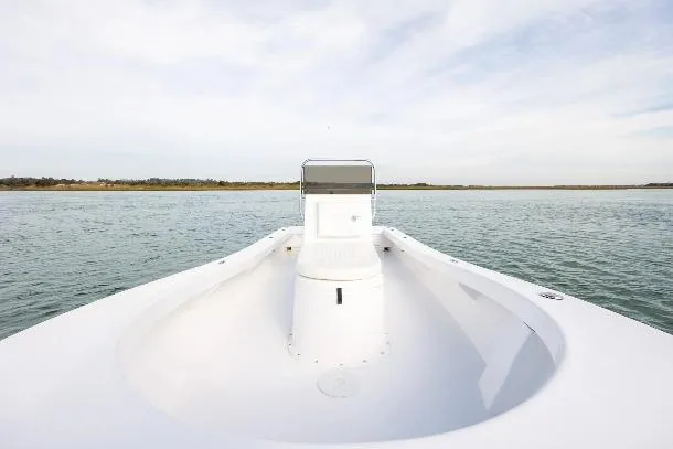 Slide: The Image of Privateer ROAMER II 2026 boat on calm water, showcasing sleek design and open deck. - 11