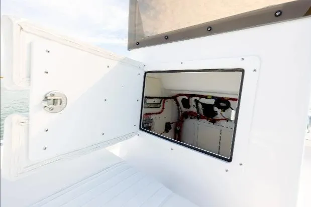 Slide: The Image of Open compartment on 2026 Privateer ROAMER II boat, showcasing interior wiring and equipment. - 12