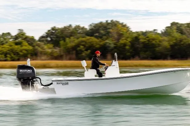 Slide: The Image of Privateer ROAMER II 2026 boat cruising on water with Suzuki outboard motor. - 13