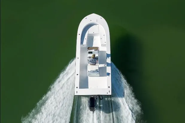 Slide: The Image of Aerial view of 2026 Privateer ROAMER II boat cruising on green water. - 14