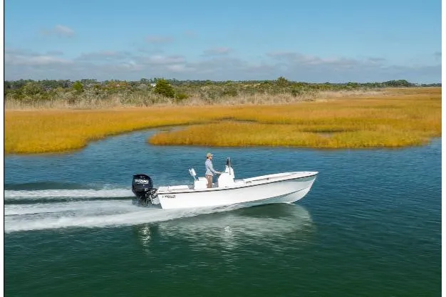 Slide: The Image of A 2026 Privateer ROAMER II boat cruising on a scenic waterway. - 2