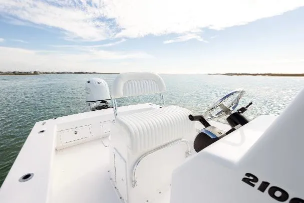 Slide: The Image of Privateer ROAMER II 2026 boat on calm water, featuring a sleek white design and modern controls. - 4