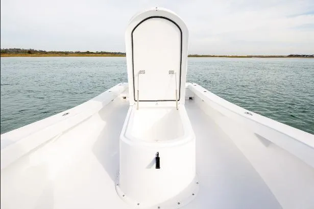 Slide: The Image of Bow storage compartment on 2026 Privateer ROAMER II boat, open on calm water. - 9