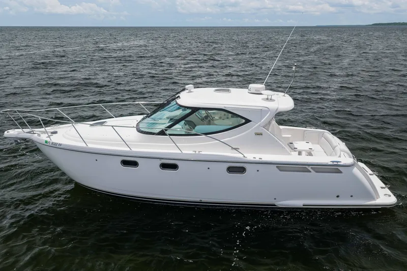 Slide: The Image of 2010 Tiara Yachts 3500 Sovran LE cruising on open water under a cloudy sky. - 3