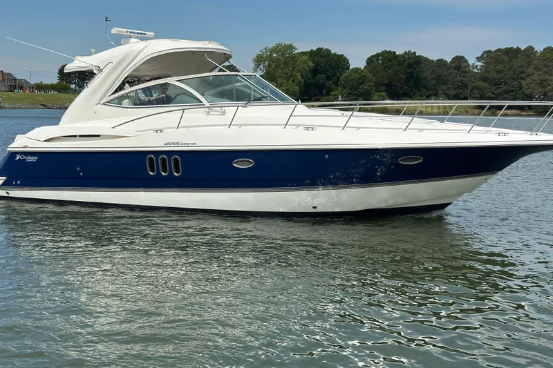 The Image of 2005 Cruisers Yachts 400 Express boat on calm water, side view. - 0