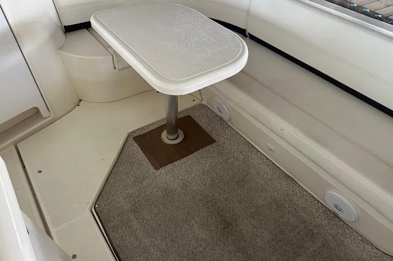 Slide: The Image of 2005 Cruisers Yachts 400 Express interior with table and seating area. - 10