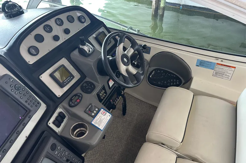 Slide: The Image of Helm of 2005 Cruisers Yachts 400 Express with steering wheel and control panel. - 12