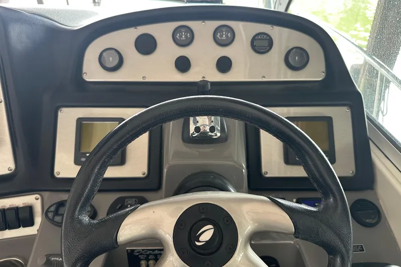 Slide: The Image of Dashboard of a 2005 Cruisers Yachts 400 Express with steering wheel and gauges. - 13