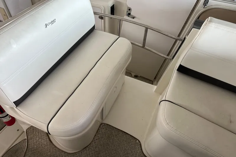 Slide: The Image of 2005 Cruisers Yachts 400 Express interior seating with white upholstery and stainless steel railing. - 18