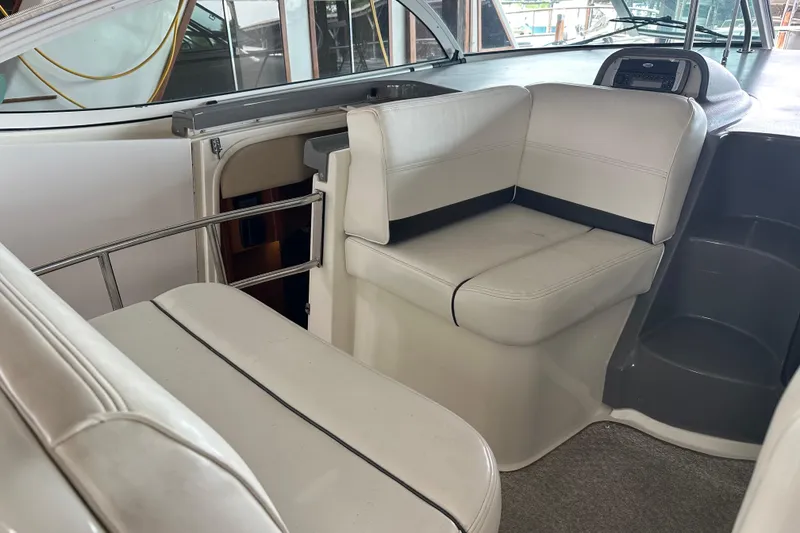 Slide: The Image of Interior seating of 2005 Cruisers Yachts 400 Express, featuring white leather upholstery. - 19