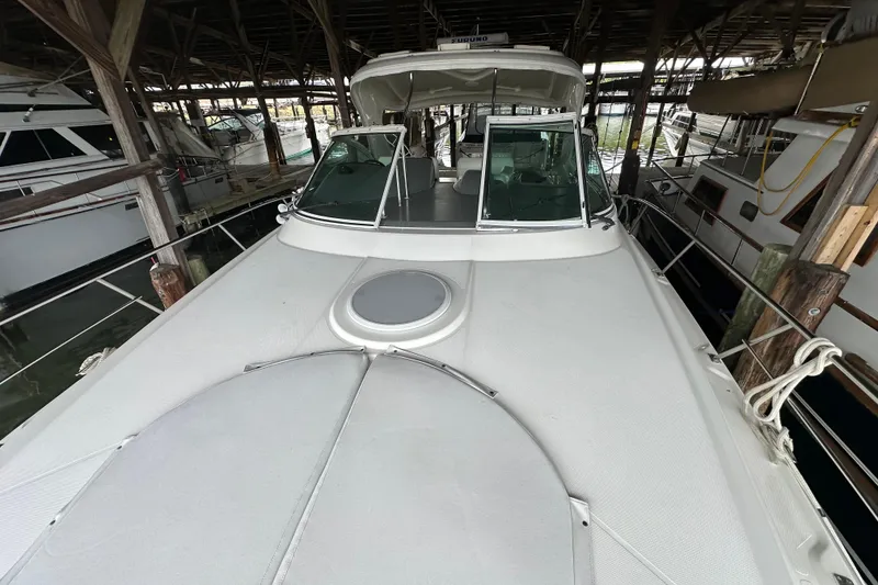 Slide: The Image of 2005 Cruisers Yachts 400 Express docked in a covered marina. - 23
