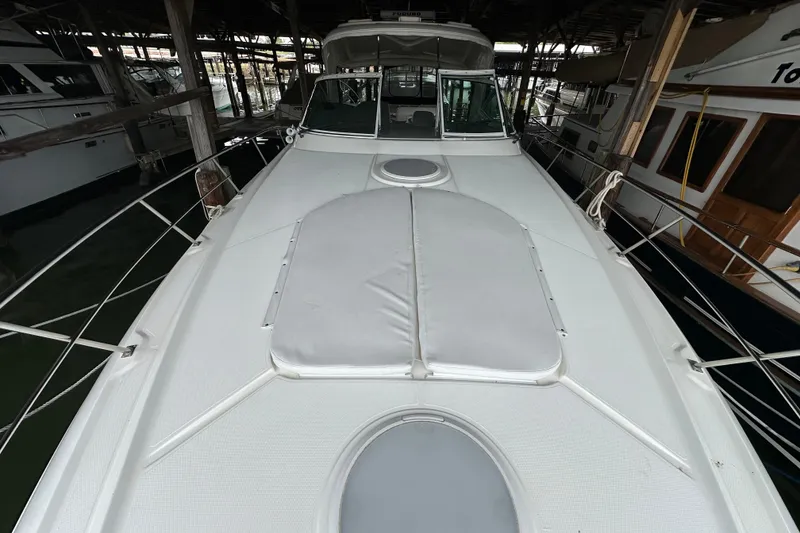 Slide: The Image of 2005 Cruisers Yachts 400 Express docked, showcasing sleek deck design and spacious layout. - 24