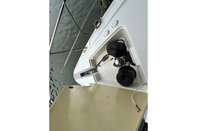 Slide: The Image of 2005 Cruisers Yachts 400 Express boat deck with anchor and fenders. - 25