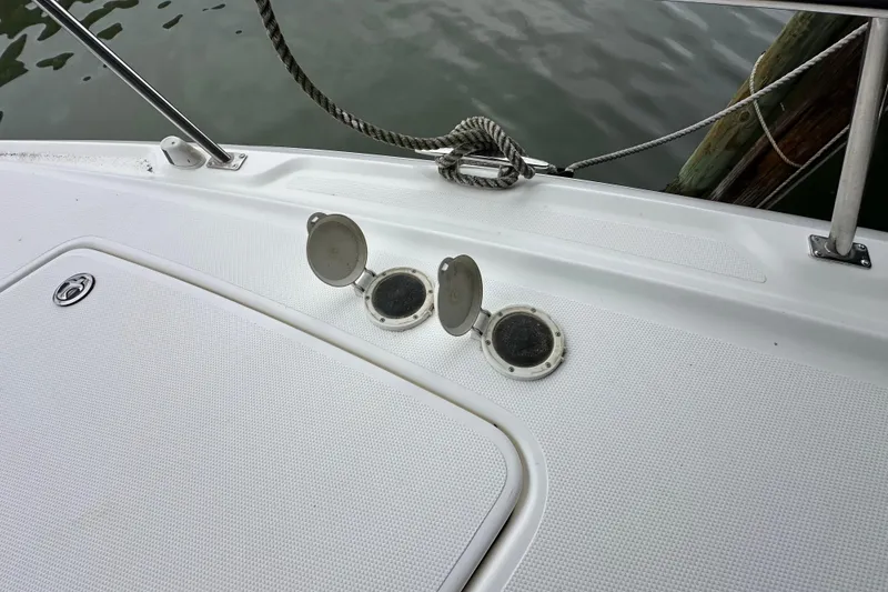 Slide: The Image of 2005 Cruisers Yachts 400 Express deck with open hatches and mooring rope. - 27
