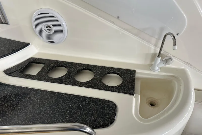 Slide: The Image of 2005 Cruisers Yachts 400 Express boat sink area with faucet and speaker. - 29