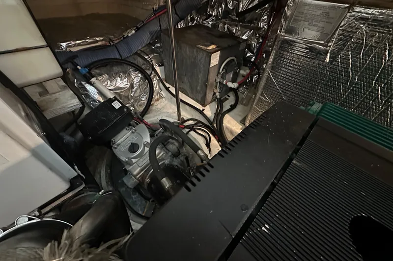 Slide: The Image of Engine room of 2005 Cruisers Yachts 400 Express with mechanical components and wiring. - 33