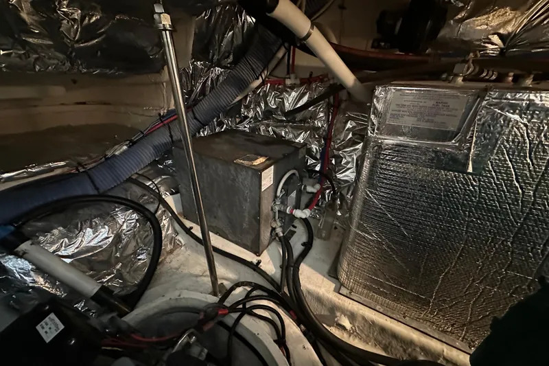 Slide: The Image of Engine room of 2005 Cruisers Yachts 400 Express with insulated components and wiring. - 35