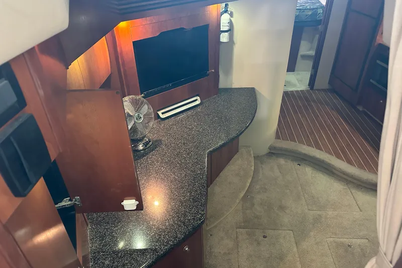 Slide: The Image of Interior of 2005 Cruisers Yachts 400 Express with granite countertop and wooden cabinetry. - 38