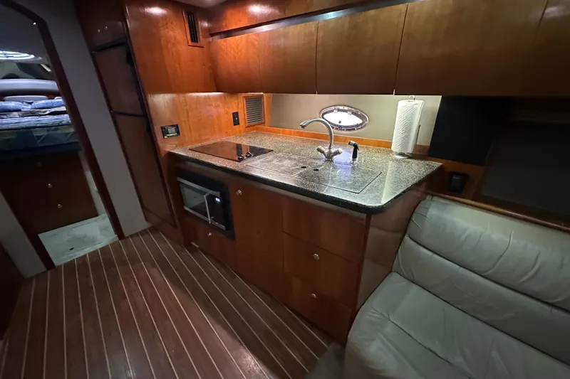 Slide: The Image of Luxurious 2005 Cruisers Yachts 400 Express interior with modern kitchen and cozy seating. - 41
